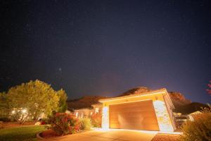 a building with a garage door at night at Pet Friendly Southern Utah Luxury FamilyHome Views in Kanab