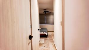 a hallway with a ceiling fan in a room at Town Center Zama Luxury Condo Hotel By Marea in Tulum +45 photos