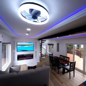 a living room with a ceiling with purple lights at Unique 3-bed Lakefront Container Home in National City