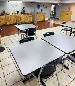 a room with tables and chairs in a kitchen at Plaza Inn in Big Spring +34 photos