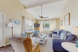 a living room with a couch and a table at The Lazy Bay in Rockport