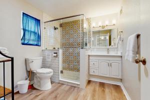 a white bathroom with a shower and a toilet at The Lazy Bay in Rockport +12 photos