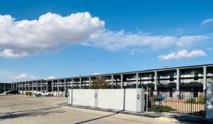 an empty parking lot with a building in the background at Plaza Inn in Big Spring