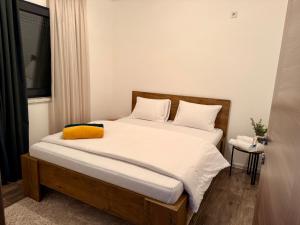 a bedroom with a bed with a yellow pillow on it at Vikendica-Villa Belvedere Srebrenik in Srebrenik +34 photos