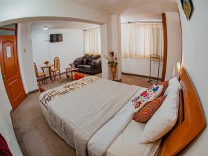 a bedroom with a large bed and a living room at Hotel San Francisco de Paula in Ayacucho +37 photos