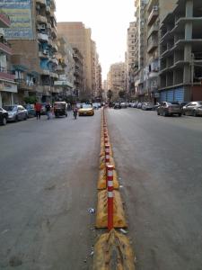 a street with a yellow and red line on the road at القوميه 