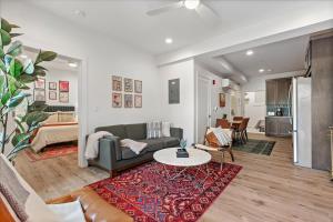a living room with a couch and a table at Modern Princeton Stay Steps from Nassau Street in Princeton +24 photos