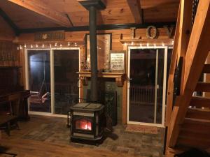 a woodburning stove in a room in a cabin at Beautiful Secluded Log Cabin in Cleveland