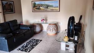a living room with a couch and a table at Petricor Casa de Temporada COP30 in Belém