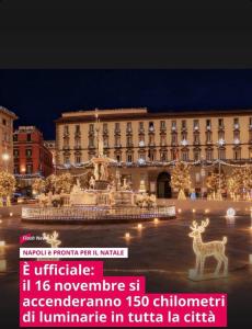 a building with a fountain and a deer in front of it at Aurora House 2 in Naples