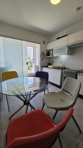 a kitchen with a glass table and chairs in a room at Garzonier in the best area of Cochabamba in Cochabamba