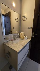 a bathroom with a sink and a large mirror at Garzonier in the best area of Cochabamba in Cochabamba
