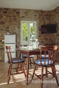 a dining room with a wooden table and chairs at La casa di Maurizio in Moneglia