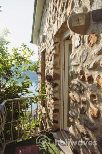 a window on the side of a stone building at La casa di Maurizio in Moneglia +46 photos