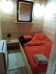 a small room with a bed in a cabin at Fruškogorske brvnare in Sremski Karlovci