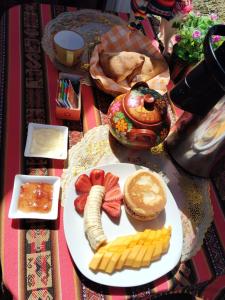 une table avec une assiette de nourriture avec du fromage et du pain dans l'établissement Uros encantos del titikaka lodge, à Puno