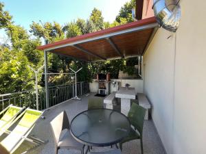 a patio with a table and chairs and a grill at Casa De Casarelhos in Cova +32 photos
