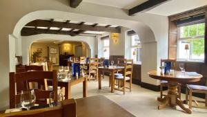ein Restaurant mit Tischen und Stühlen in einem Raum in der Unterkunft Pheasant Inn in Kirkby Lonsdale