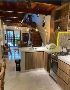 a kitchen with a sink and a stove top oven at Chalé aconchegante in Gravatá