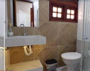 a bathroom with a sink and a toilet at Chalé aconchegante in Gravatá +24 photos