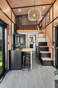 a kitchen and dining area of a tiny house at Tiny Home Escape w Sauna and Plunge in Whangarei