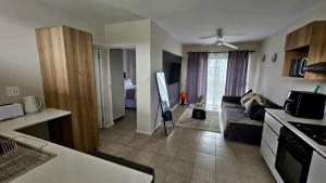 a kitchen and a living room with a couch in a room at Bliss Ballito 2 in Ballito