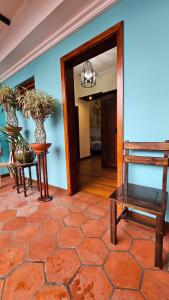 a hallway with a table and a bench in a room at Casa Hibiscus Boutique Hotel in Cuenca