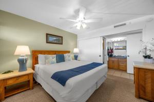 a bedroom with a bed and a ceiling fan at Sugar Beach 511 in Kihei +40 photos