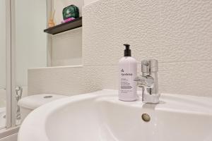 a white bathroom sink with a soap bottle on it at Spacious 4BR Townhouse, Sleeps 9, Fast WIFI, FREE PARKING, Contractor friendly in Colchester +32 photos