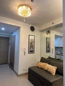 a living room with a couch and a chandelier at Overnight @ Shakhbot's in Manila +18 photos