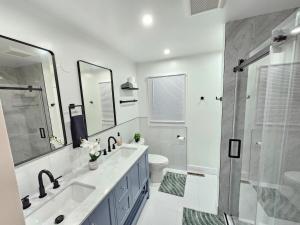 a bathroom with a sink and a toilet and a shower at Modern Retreat near Six Flags & Naval Base in Waukegan +41 photos