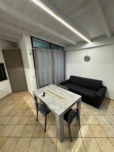 a living room with a table and a couch at IL moro in Acireale