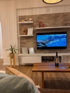 a living room with a flat screen tv on a wall at Pirca NQN in Neuquén