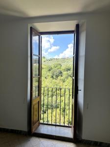 an open door to a balcony with a view at Torri In Sabina Apartment in Torri in Sabina