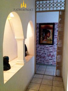 a hallway with a painting of a man in a picture at Platinum Palace Guest House in Rustenburg