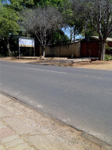 an empty street with a sign on the side of the road at Platinum Palace Guest House in Rustenburg