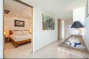 a bedroom with a bed and a mirror at Luxury Penthouse with Private Pool at View Phuket F9 in Ban Karon +69 photos