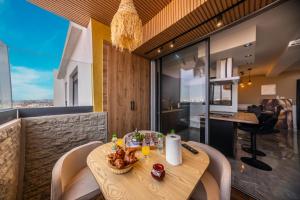 a dining room with a table with food on it at Appartement avec salle de cinema in Agadir +19 photos