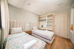 a bedroom with two beds and a window at Appartement avec salle de cinema in Agadir