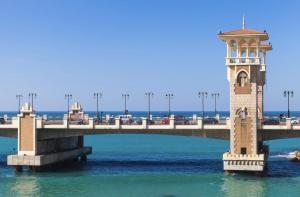 a bridge over the water with a clock tower at Nabeel Homes - Panoramic Seaview Condo in Stanley in Alexandria +121 photos