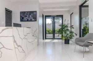 a living room with a table and a chair at Rooftop Pool Condo in Kingston in Kingston