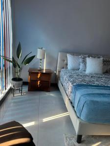 a bedroom with a bed and a table with a lamp at Rooftop Pool Condo in Kingston in Kingston