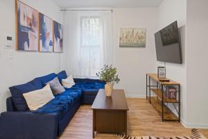 a living room with a blue couch and a table at 2BD Comfy Manhattan Home in New York