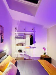 a purple bedroom with a bed and a purple ceiling at Mood's Home BLQ in Bologna +10 photos