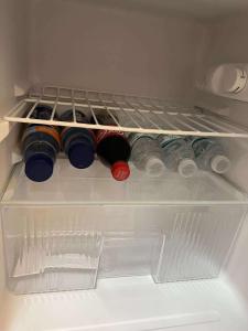 a refrigerator filled with lots of bottles of wine at Compostela Guest Room #3 Terrace, Rooftop, WiFi, Netflix in Compostela