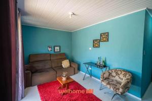 een woonkamer met een bank en een tafel bij Sitio com piscina e lazer completo em Mongagua in Agenor de Campos