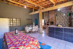 een keuken en een eetkamer met een tafel en een tafel bij Sitio com piscina e lazer completo em Mongagua in Agenor de Campos