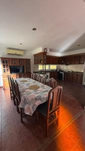 a kitchen with a table and chairs and a kitchen with at 9deJulio90 in Colón