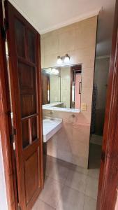 a bathroom with a sink and a mirror at 9deJulio90 in Colón
