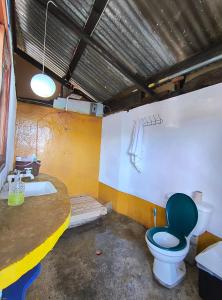 a bathroom with a toilet and a bath tub at ELOA Atitlán in San Marcos La Laguna